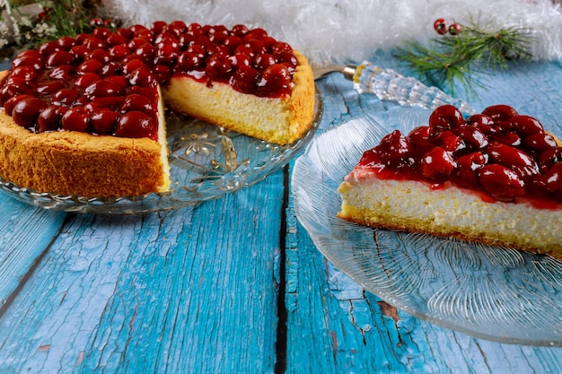 Tasty cherry cheesecake on wooden blue table