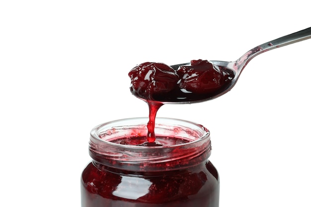 Tasty cherry jam isolated on white background