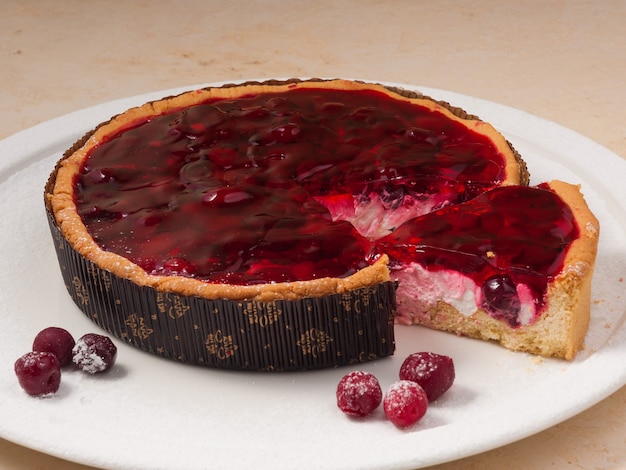 Tasty cherry pie on a white plate decorated with cherry berries