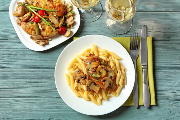 Tasty chicken marsala with pasta on table