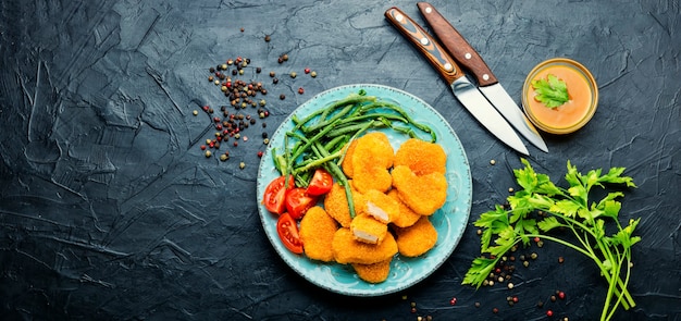 Tasty chicken nuggets with cowpea and tomato.Copy space