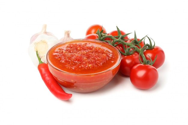 Tasty chili sauce in bowl isolated on white background