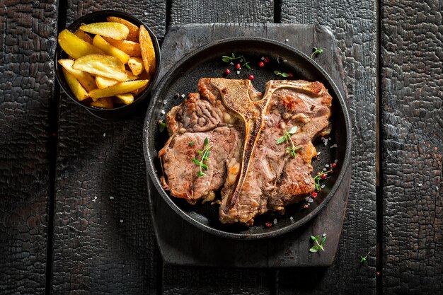 Tasty chips and tbone steak with herbs and salt