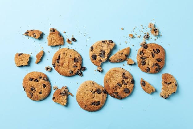 Tasty chocolate chip cookies on blue background, top view