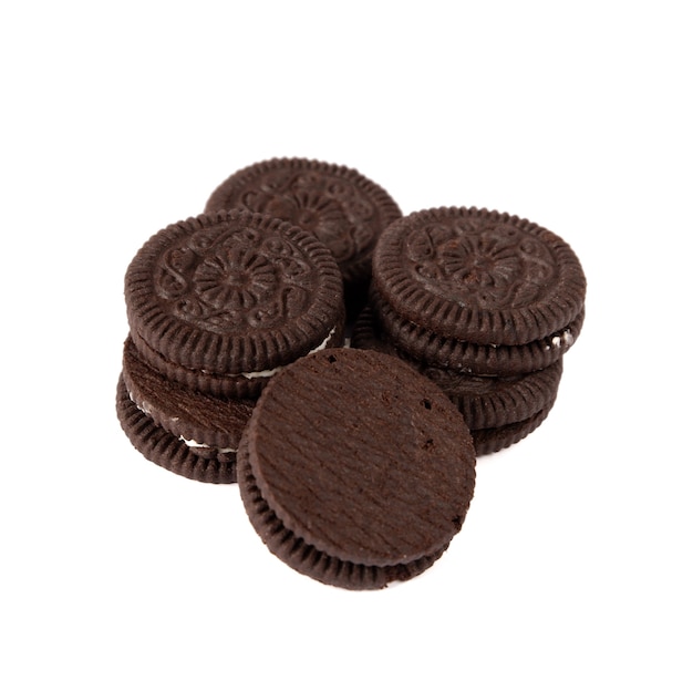 Tasty chocolate cookies with cream on white background