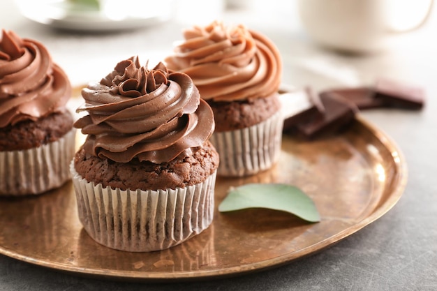 Tasty chocolate cupcakes on metal tray