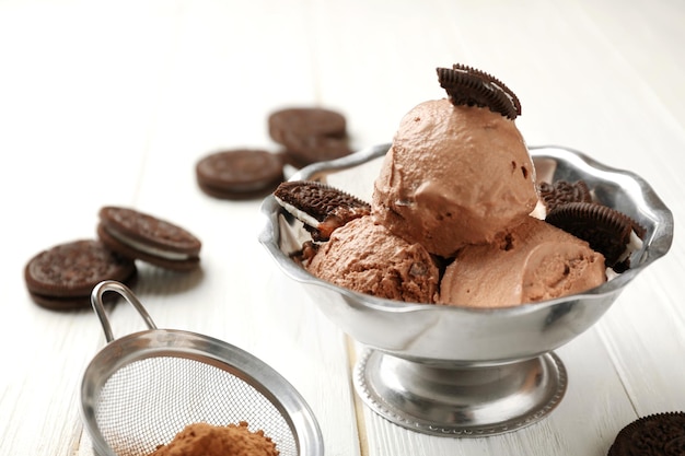 Tasty chocolate icecream with cookies on table