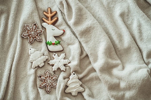 Tasty Christmas cookies on the bed