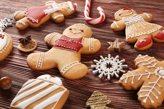 Tasty Christmas cookies and decor on wooden table, close up view