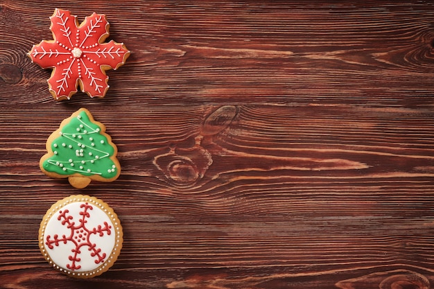 Tasty Christmas cookies on wooden table