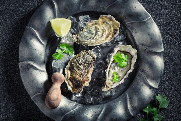 Tasty and cold oysters with lemons and coriander