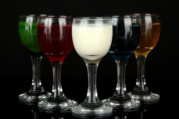 Tasty color liquors isolated on black