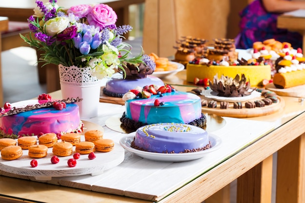 Tasty colorful cakes on the showcase with fresh summer berries