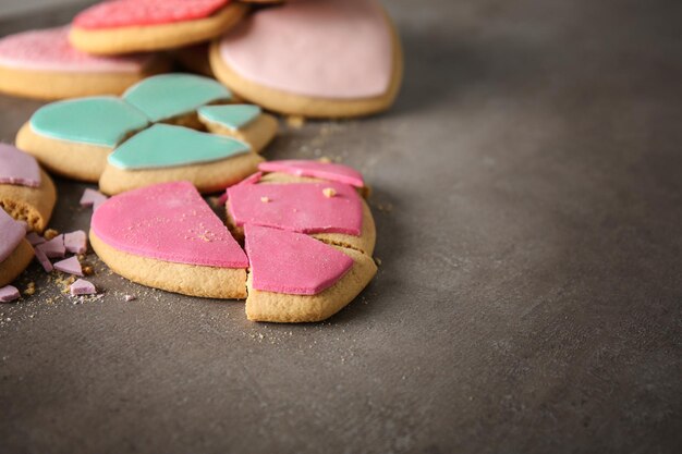 Tasty colourful heart shaped cookies on grey background