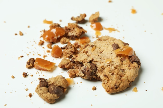 Tasty cookie with caramel on white background