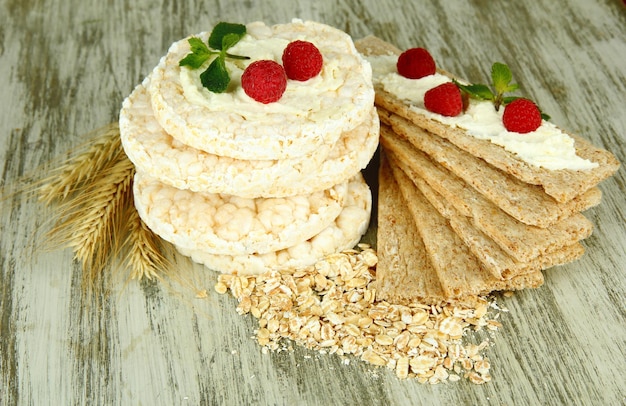 Tasty crispbread with berries on wooden table