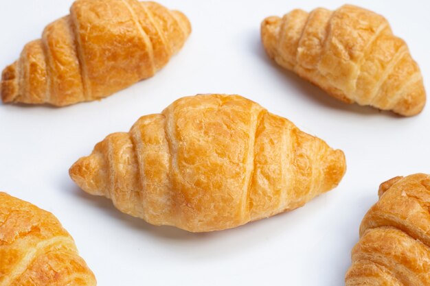 Tasty croissants on white surface