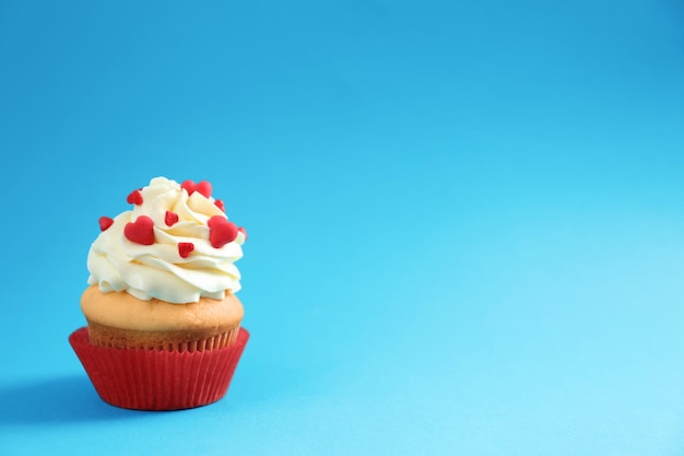 Tasty cupcake on color background