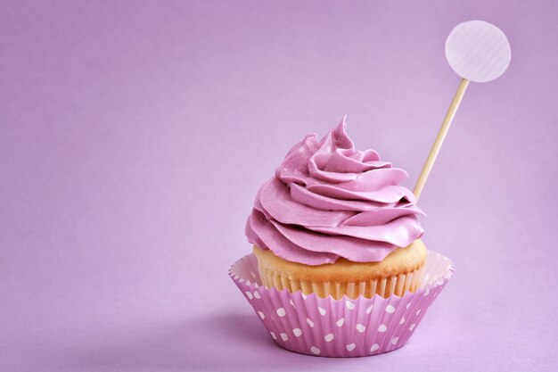 Tasty cupcake on color background