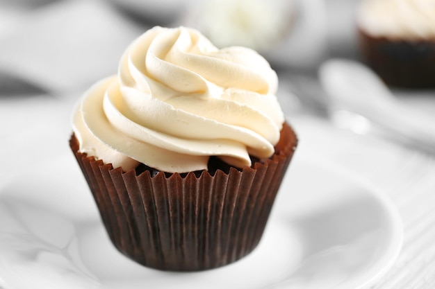 Tasty cupcake on served table close up