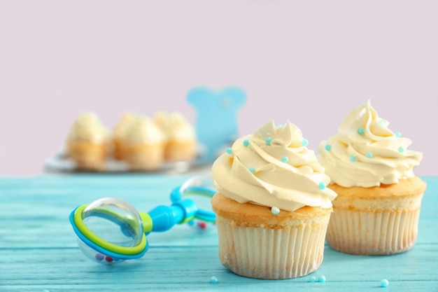 Tasty cupcakes for baby shower party on table