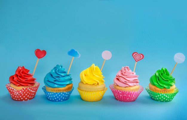 Tasty cupcakes on color background