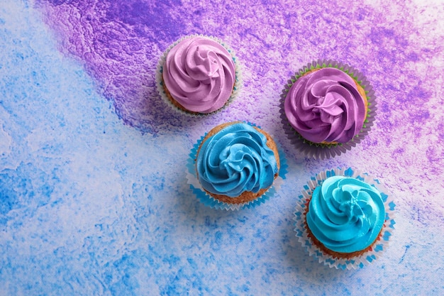 Tasty cupcakes on color background