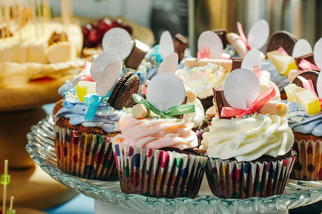 Tasty cupcakes on a crystal dish with empty white signs Clouseup