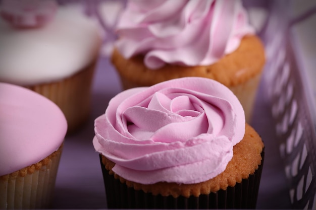 Tasty cupcakes on tray closeup