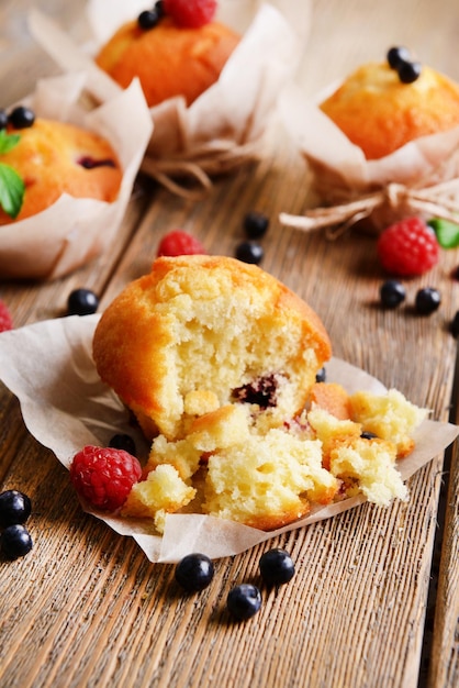 Tasty cupcakes with fruits on table closeup