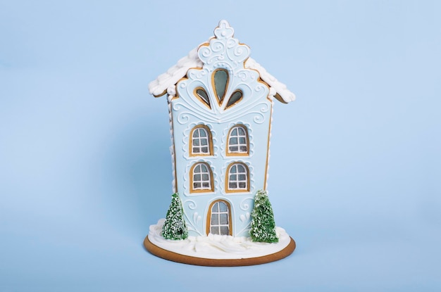 Tasty and cute gingerbread house isolated on a blue background