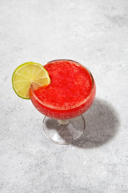 Tasty daiquiri cocktail with lime slice high angle