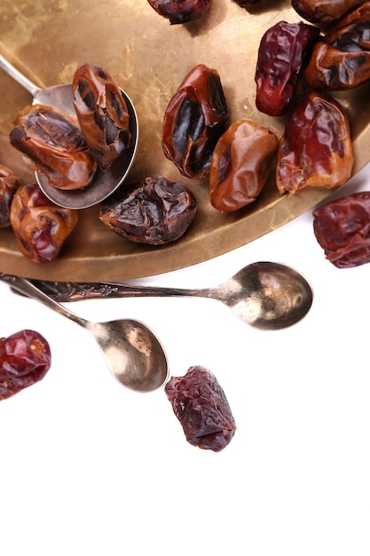 Tasty dates fruits on old metal tray isolated on white