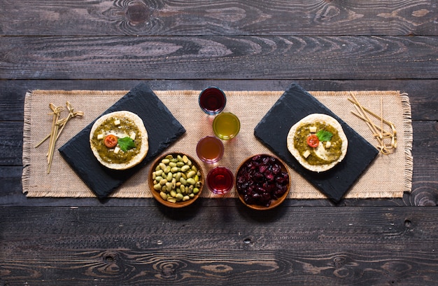 Tasty and delicious bruschetta with avocado, tomatoes, cheese, herbs, chips and liquor,. 