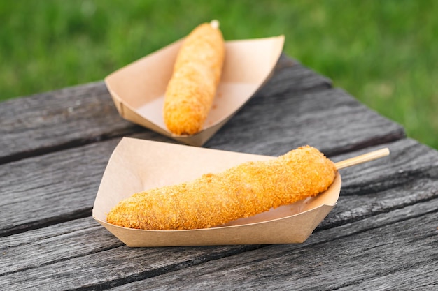 Tasty and delicious unhealthy fast food joint Hot dog Korean style deep fried crusted flour stuffed with sausage selective focus