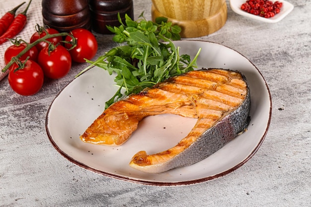 Tasty delicous grilled salmon steak with arugula