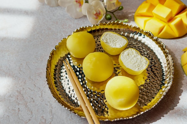 Tasty dessert Mochi with mango fruit on grey background close up