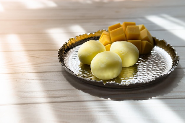 Tasty dessert Mochi with mango fruit on wooden background