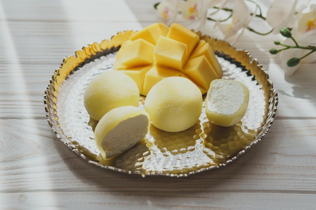 Tasty dessert Mochi with mango fruit on wooden background