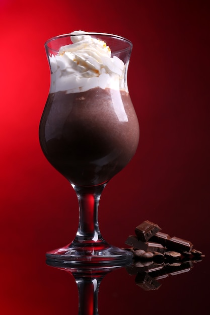 Tasty dessert with chocolate cream and orange sauce on dark color background