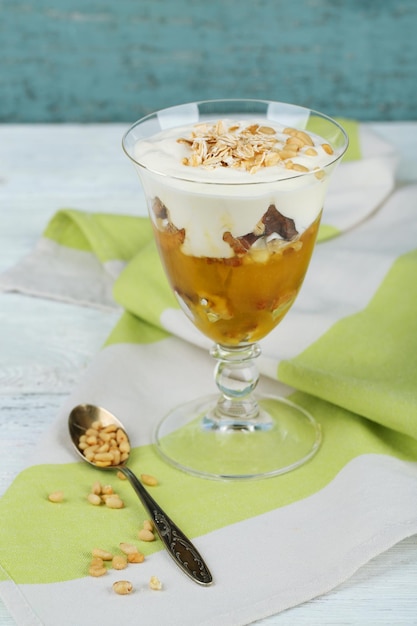 Tasty dessert with oat flakes and honey on table