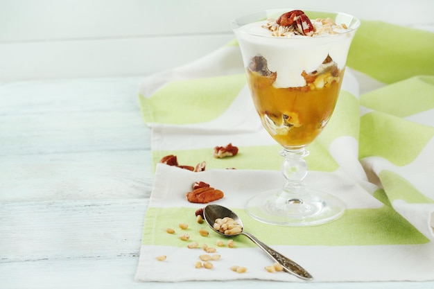 Tasty dessert with oat flakes and honey on table