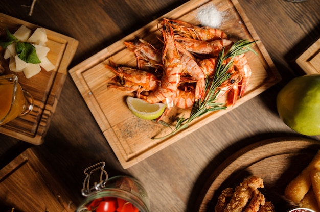 Tasty dish of large shrimps on a wooden table