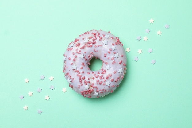 Tasty donut on mint background