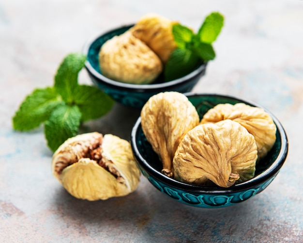 Tasty dried figs on a grey concrete table