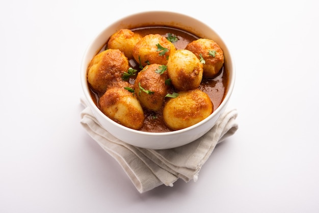 Tasty dum aloo or whole potatoes spicy curry is a popular main\
course recipe from india