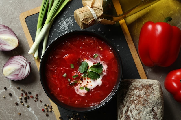 Tasty eating with borscht on gray surface