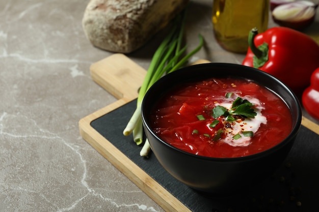 Tasty eating with borscht on gray surface