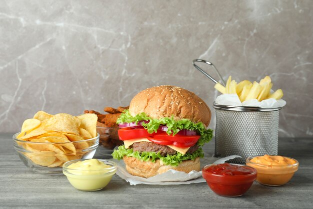 Tasty fast food on gray textured table