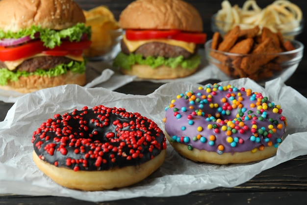 Tasty fast food on rustic wooden table